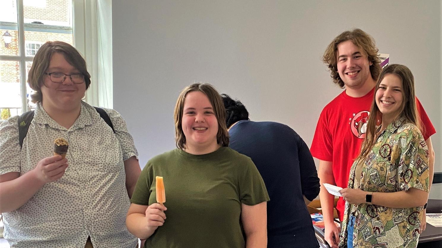 Students eating ice cream cones and popsicles.