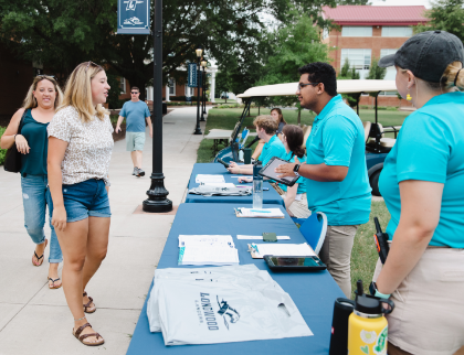 Peer Mentors work at a table.