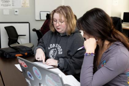 Students work on a laptop in the QR Center.