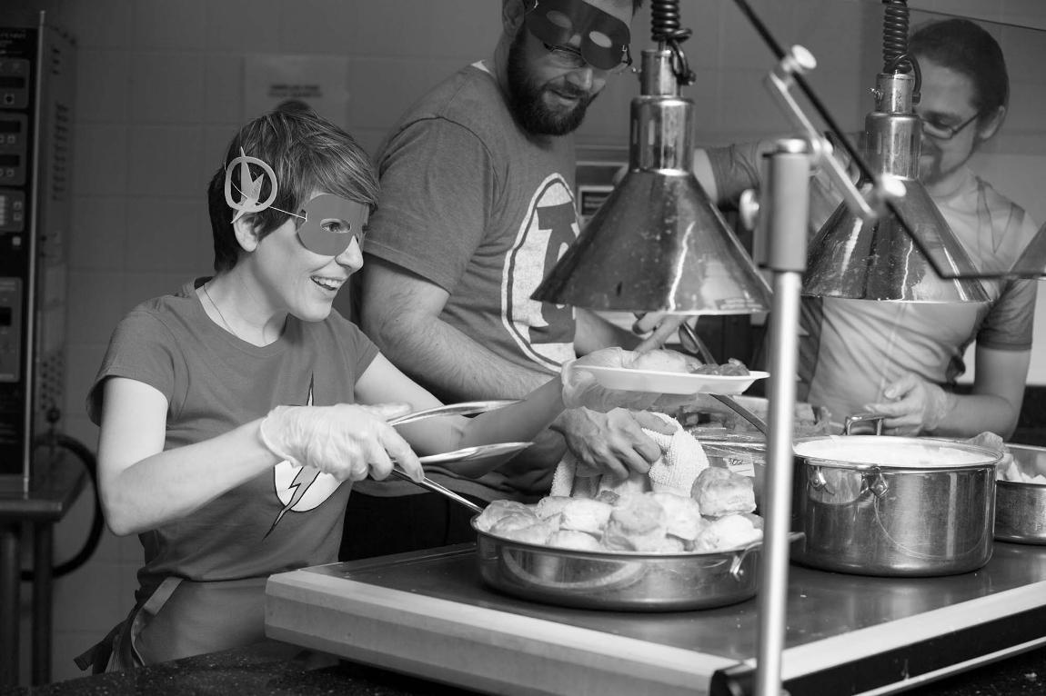 Faculty serving breakfast at Late Night Breakfast