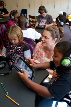 Longwood teacher candidate Allison Kellinger '13 helps student in a fifth-grade class at Bacon District Elementary School in Charlotte County, Va. Kellinger is among a group of Longwood students helping Charlotte County schools adopt innovative teaching methods