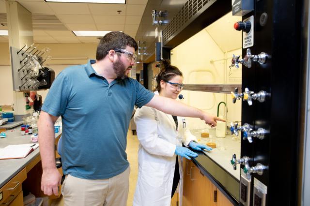 Student and professor working in a campus lab